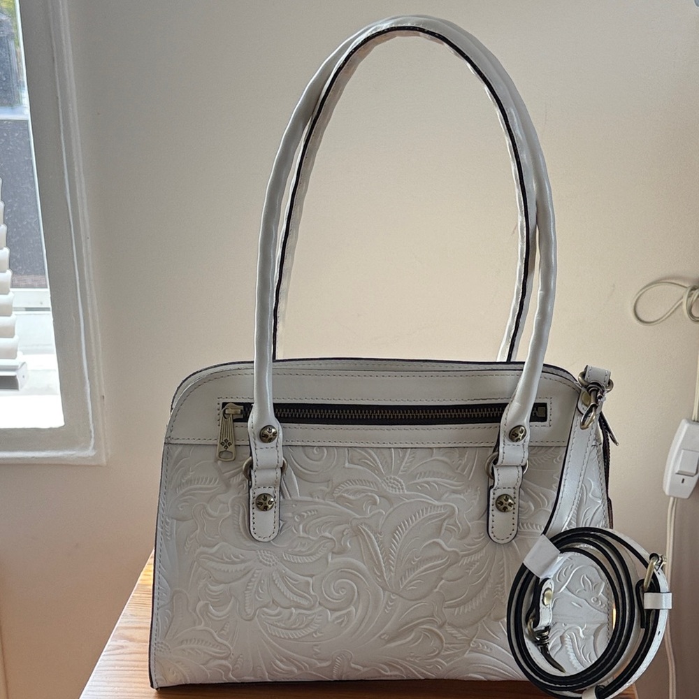 COMPLETELY NEW.  Leather White Embossed  bag with attached shoulder strap